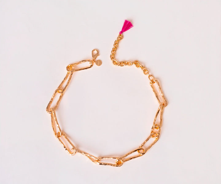 Gold Connecting Worlds Necklace with fuchsia tassel drop