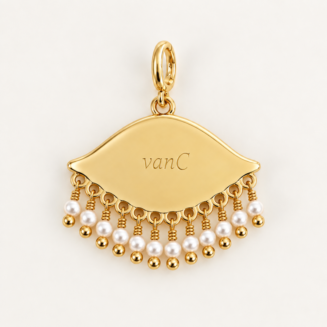 Back of the See the World 18K gold-plated eye charm with white pearl bead detailing, opening oval clasp and engraved Blauw van C branding.
