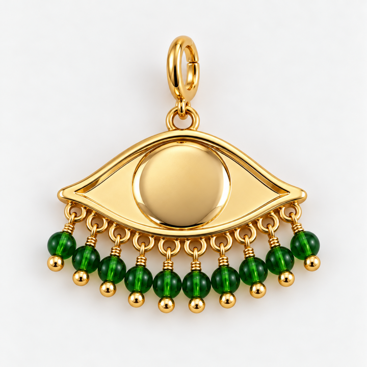 Gold plated See the world eye pendant charm with dangling green faceted beads on a clean white background.