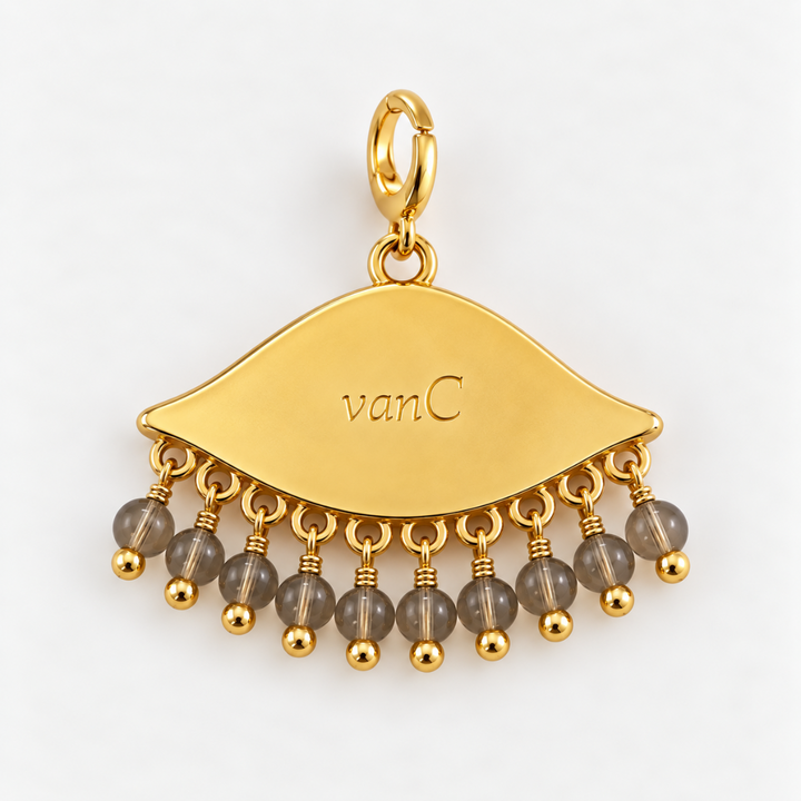 Gold plated See the world  eye-shaped charm pendant with dangling sand translucent beads, shown on a clean white background. The brand logo 'vanC' is engraved on the charm.