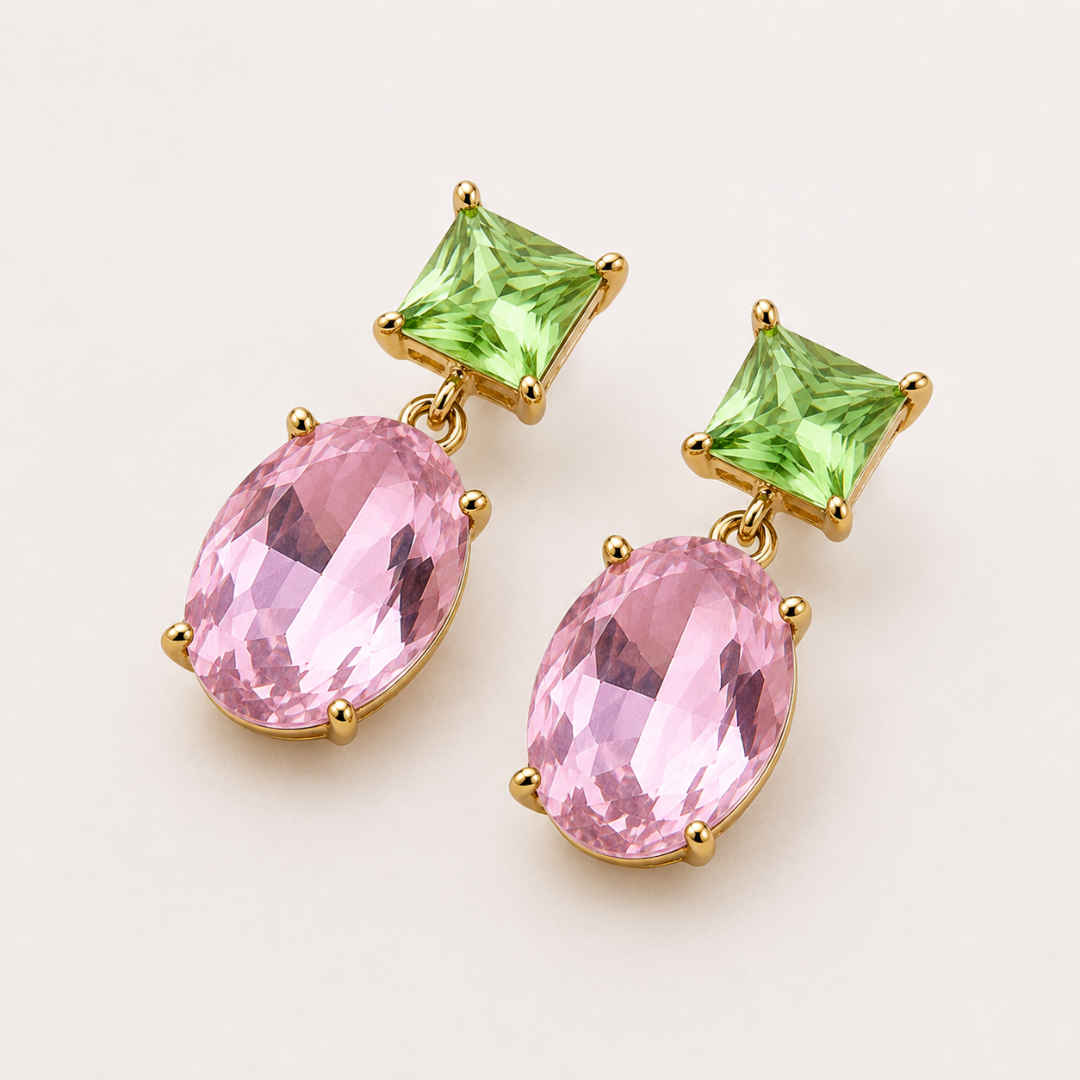 Two-Way Glow Crystal Earrings with pistachio green square-cut crystals and faceted pink oval drops in 18K gold plating, photographed in a lay-flat arrangement.