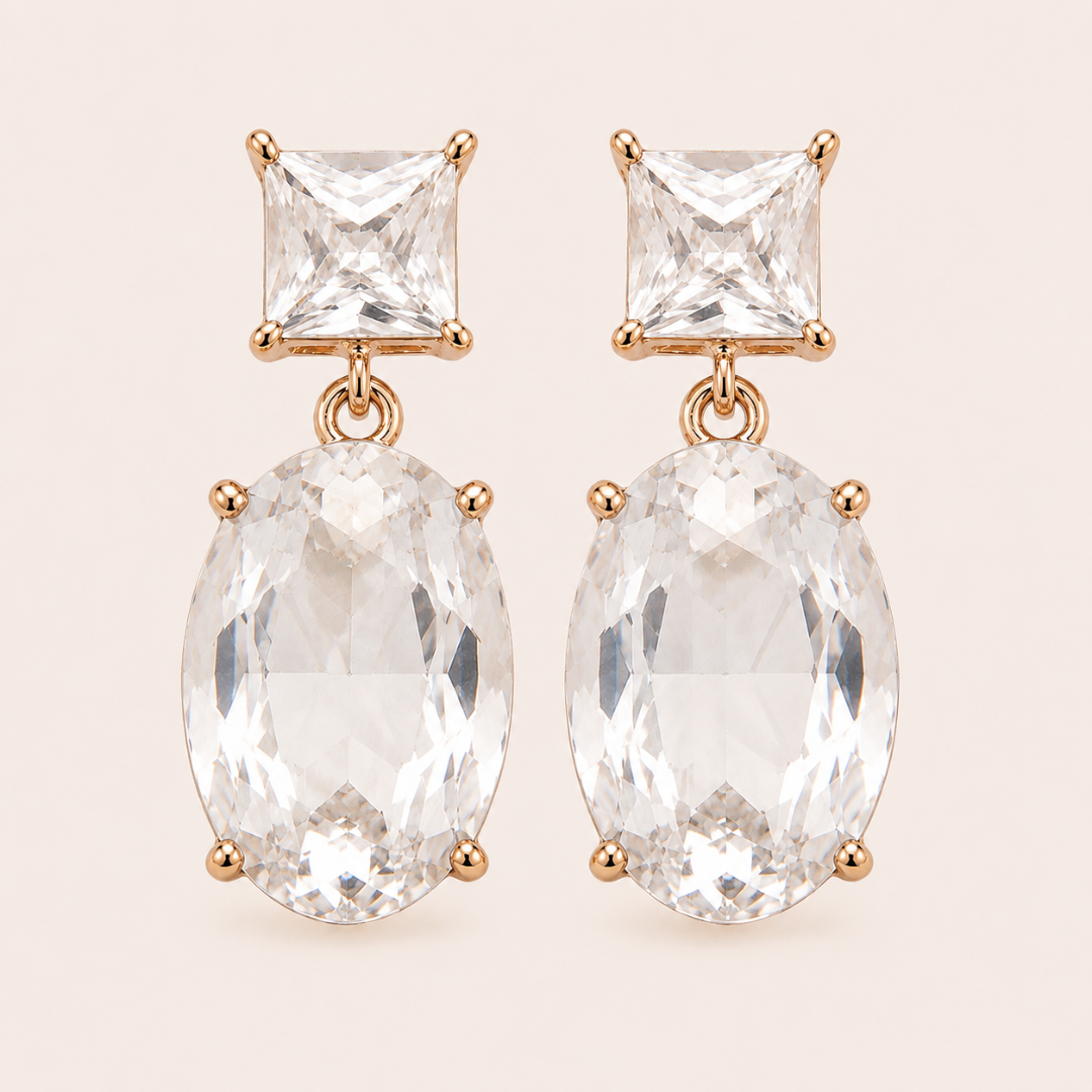 Two Way Glow clear crystal drop earrings with square and oval glass crystals in 18K gold-plated settings, front view.