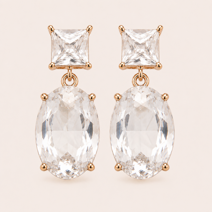 Two Way Glow clear crystal drop earrings with square and oval glass crystals in 18K gold-plated settings, front view.